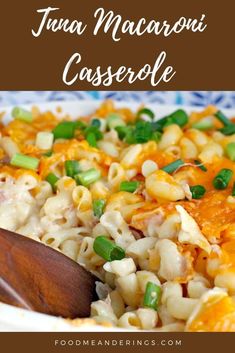 macaroni and cheese casserole in a bowl with a wooden spoon on the side