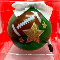 a christmas ornament with a football and stars on it