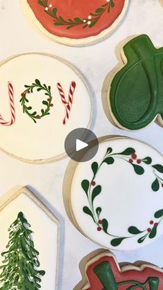 cookies decorated with christmas decorations and cookie cutters on top of a white tablecloth