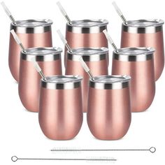 six copper colored cups with straws in them