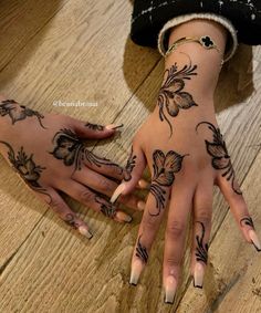 two hands that have tattoos on them