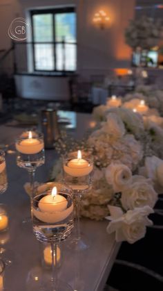 white flowers and candles are on the table