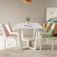 a white table with four chairs and a plant on top of it in a room