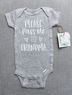 a baby bodysuit with the words please pass me to grandma on it next to a tag