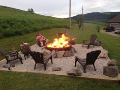 a fire pit with chairs around it