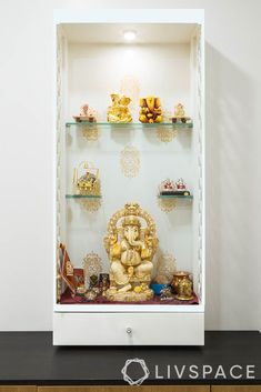 there is a shelf that has many items on it in front of some shelves with buddha figurines