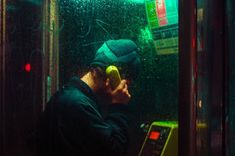 a man is talking on the phone while holding an apple