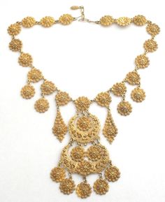 Statement Jewelry - This is a Egyptian style gold tone bib necklace with a design that looks like cannetille. It is 21" long, which includes the 2" extension, so necklace can be worn from 19" to 21" in length. The center from top to bottom is 5" long. Fabulous necklace. Gold Filigree Costume Jewelry Necklace, Gold Filigree Dangle Necklaces, Gold Choker Bib Necklace As Costume Jewelry, Gold Bib Choker Costume Jewelry, Gold Costume Jewelry Necklace With Intricate Design, Ornate Gold Choker With Intricate Design, Elegant Gold Bib Necklace With Adjustable Chain, Gold Bib Necklace Costume Jewelry, Gold Costume Jewelry Necklace, 16 Inch Length