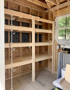 an unfinished room with wooden shelves in it