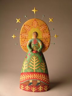 a ceramic figurine with stars on it and a woman holding a star above her head