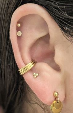 "This clicker hoop is made to create the appearance of three hoops with only one piercing. It fits best worn in a conch piercing in the space where the three hoops can rest toward the bottom of the conch. The hinge is placed for it to fit for the LEFT ear, though if your piercing is in the right ear (as is the case with the model) the hoop can be threaded backwards through the piercing the way a labret post would be threaded. The hinge is attached to the center hoop which is 10mm interior diamet Daith And Conch Earrings, Multiple Conch Piercing, Thick Conch Hoop, Conch Jewelry Hoop, Stretched Septum Jewelry, Conch Hoop Jewelry, Earring Placements, Coin Slot Piercing, Conch Piercing Hoop