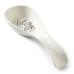 a white spoon with the words love and cok on it's side is shown