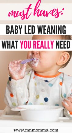 a baby eating food with the words must haves baby led weaning what you really need