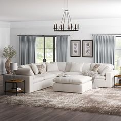 a living room with white furniture and blue drapes