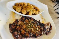 a steak and some tater tots on a plate