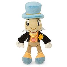 a stuffed animal with a top hat on it's head and blue pants, holding a star in his left hand