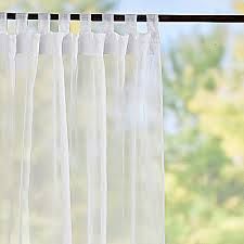 white curtains hanging on a window sill in front of a tree outside the window