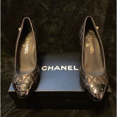 Here They Are! These Chanel Pumps Feature Super Soft Quilted Lambskin Leather. The Toe Features The Cc Logo And Outer Edge Features A Stud Of The Chanel Flower. These Pumps Are New, Unworn In Euro Size 37.5 (Us 7.5). Included Is Original Chanel Box And Two Chanel Dust Sacks, One For Each Shoe. You Cannot Find These Luxery Shoes Unworn At This Price. Make An Offer, Make Them Yours. Chanel Flower, Chanel Pumps, Chanel #1, Chanel Box, Black Patent Leather Pumps, Nike Tennis Dress, Round Toe Pumps, Platform High Heels, Leather Cap