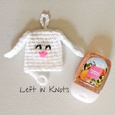 a crocheted bunny ornament next to a bottle of hand sanitizer