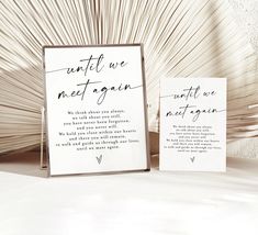 two wedding signs sitting next to each other on top of a white tablecloth covered floor