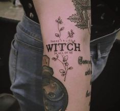 a person with a tattoo on their arm that says, there's a little witch in all of us