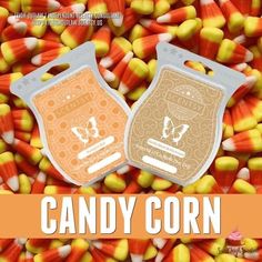 two bags of candy corn sitting next to each other