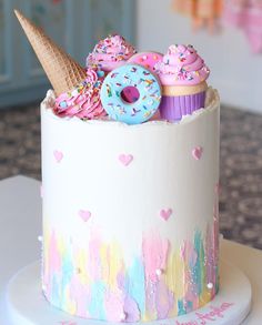 there is a cake decorated with donuts and sprinkles