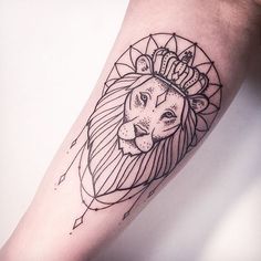 a lion with a crown on its head is shown in black and white tattoo style