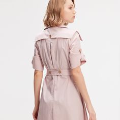 A safe bet in any wardrobe, the trench dress is available here with a tailored collar and wide flaps on the shoulders that give character to the silhouette. Adorned with refined metal buttons, generously flared, this timeless piece is cut from a breathable poplin slightly stretch. To feminize with heels or to wear with sneakers for a more casual and current look. Main fabric:  62% Cotton 35% Nylon 3% Elastane Machine wash gentle cycle (30 degrees max) Fitted Belted Dress With Buttons, Elegant Collared Belted Dress With Button Closure, Chic Belted Dress With Buttons For Office, Chic Belted Dress With Button Closure For Work, Chic Daywear Belted Dress With Buttons, Belted Dress With Button Closure For Work, Belted Dress For Workwear, Pink Belted Dress For Work, Chic Knee-length Belted Dress With Buttons