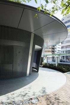 the circular building is next to some trees