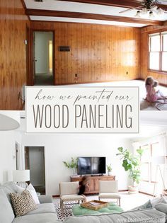 a living room filled with furniture and a sign that says how we painted our wood paneling