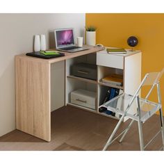 a laptop computer sitting on top of a wooden desk next to a white chair and yellow wall