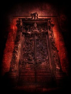 an ornate wooden door with carvings on the front and sides, against a dark background