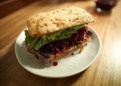 a sandwich with meat and lettuce on a plate