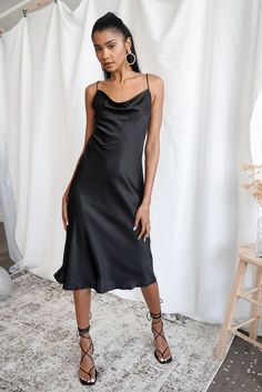 A maxi dress featuring a cowl neck, and cami straps. Fitted Bias Cut Midi Dress With Cowl Neck, Fitted Slip Dress With Cowl Back, Fitted Cowl Neck Maxi Dress For Date Night, Fitted Bias Cut Slip Dress With Cowl Neck, Fitted Cowl Neck Midi Dress, Spring Fitted Slip Dress With Cowl Back, Summer Cowl Neck Midi Dress For Night Out, Fitted Cowl Neck Midi Dress For Date Night, Fitted Slip Dress With Cowl Back For Date Night