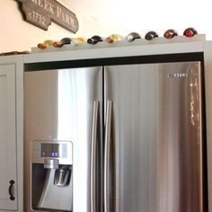 a stainless steel refrigerator with ice and water dispensers on the top shelf