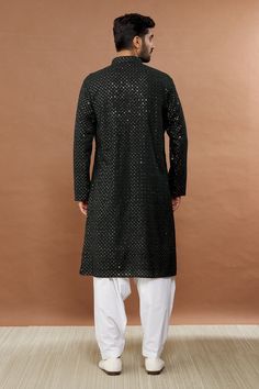 Black kurta with sequin embroidery and mandarin collar. Paired with white patiala.
Component: 2
Pattern: Embroidered
Type Of Work: Sequin
Neckline: Mandarin
Sleeve Type: Full
Fabric: Cotton Blend
Color: Black
Other Details: 
Sequin work
Occasion: Sangeet - Aza Fashions Sequin Traditional Wear For Party In Transitional Season, Traditional Party Wear With Sequins For Transitional Season, Sequin Traditional Wear For Party And Transitional Seasons, Black Sequined Wedding Kurta, Black Kurta With Zari Work For Celebration, Traditional Wear With Mirror Work For Eid, Party Black Kurta With Sequins, Black Sequined Sherwani For Festive Occasions, Festive Black Sequined Bandhgala