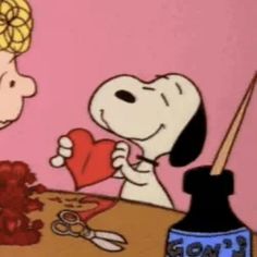 a cartoon dog is holding a heart in front of a man who is sitting at a table