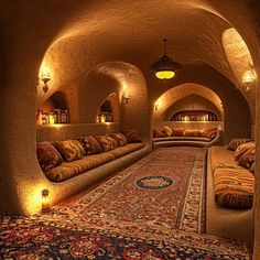 a living room filled with lots of couches and rugs