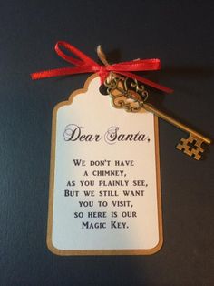 a key is attached to a card with a red ribbon