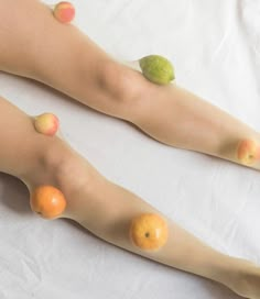 a woman's legs with fruit on them