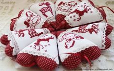 four red and white christmas ornaments on a lace doily