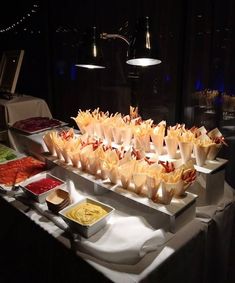 a buffet table filled with lots of food and condiments on top of it