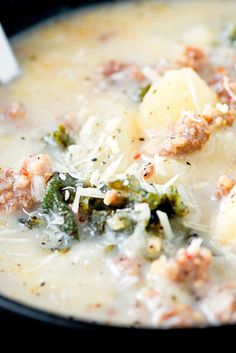 a close up of a bowl of soup with broccoli and cheese in it