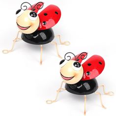 two ladybug figurines sitting side by side on top of each other