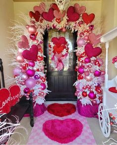 valentine's day decorations in pink, red and white with hearts on the front door