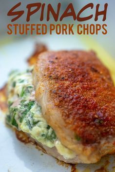 a close up of food on a plate with the words spinach stuffed pork chops