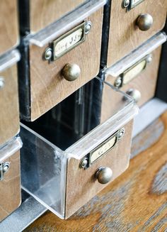 several drawers are stacked on top of each other with metal pulls and knobs in them