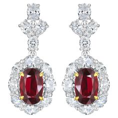 • 18KT Two-Tone • 15.48 Carats • Sold as a pair (2 earrings in total) • Number of Oval Rubies: 2 • Carat Weight: o 4.02ct o Color: Vivid to Deep Red o GRS2019-091693 o 4.04ct o Color: Vivid Red o GRS2019-091694 • Number of Oval Diamonds: 24 • Carat Weight: 7.42ctw • This beautiful one-of-a-kind pair of earrings showcases a remarkable pair of natural oval cut red rubies. Both rubies are GRS certified and have a combining total weight of 8.06 carats. Originating from Mozambique, the rubies exubera Elegant Red Oval Diamond Earrings, Luxury Red Oval Earrings, Luxury Ruby Earrings Fine Jewelry, Luxury Red Ruby Earrings, Luxury White Ruby Earrings, Ruby And Diamond Earrings, Gold For Sale, 2 Earrings, Oval Cut Diamond