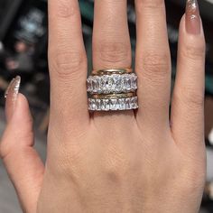 a woman's hand with two rings on it and one ring in the middle